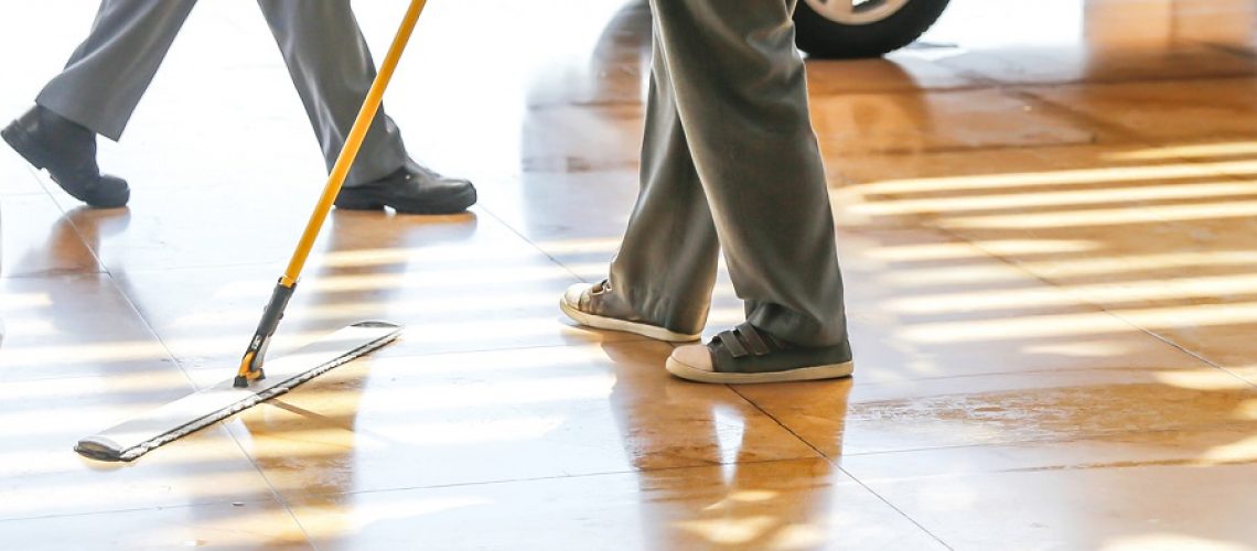 Adult man mopping floor
